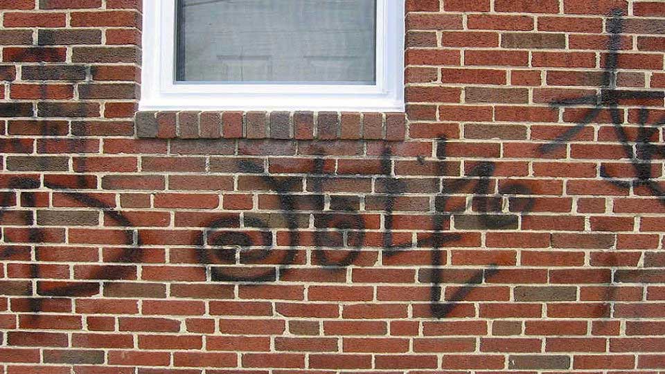 Graffiti on wall before, Grime Busters Power Washing